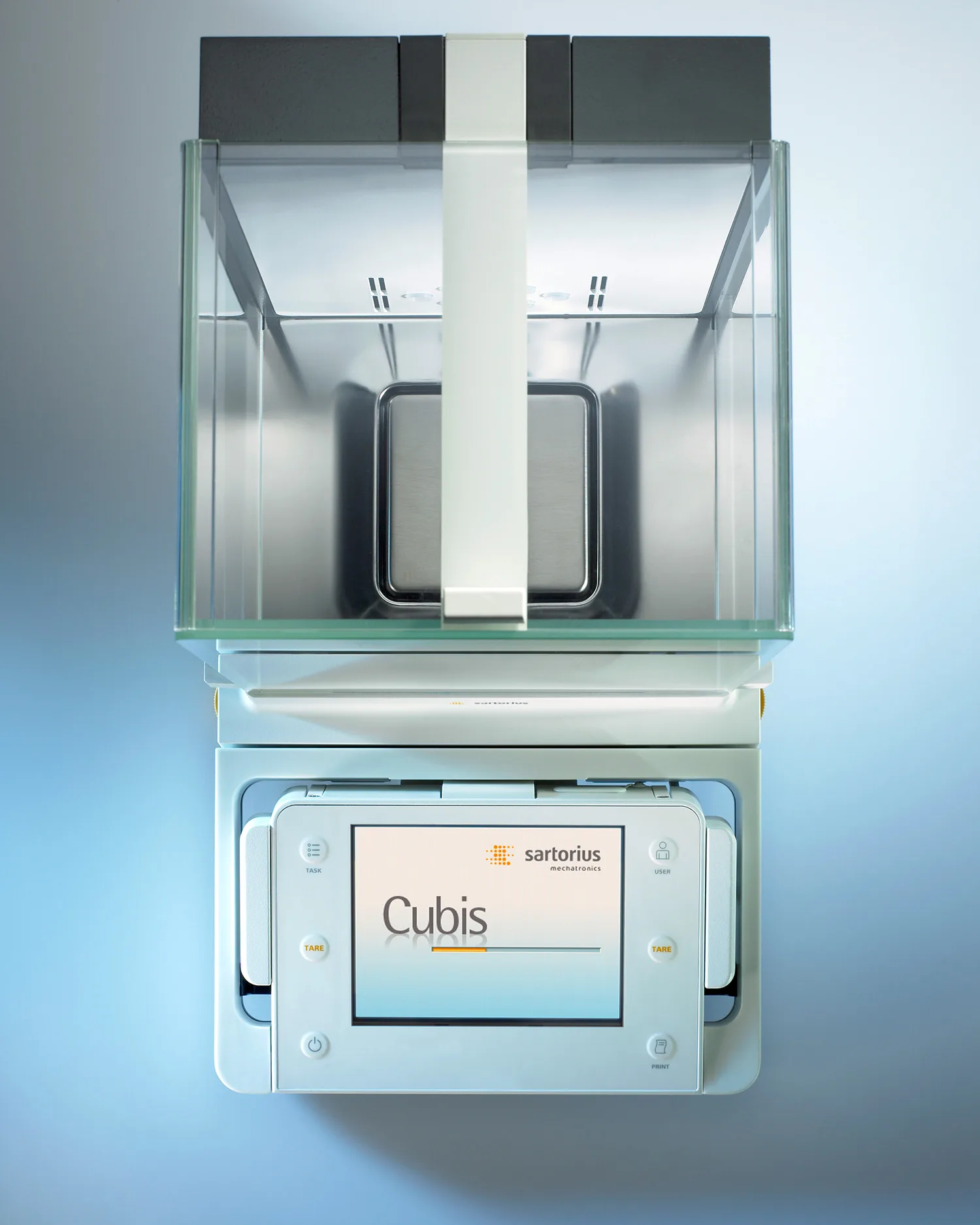 A Sartorius Cubis laboratory device with a touchscreen display and keypad on a reflective surface.